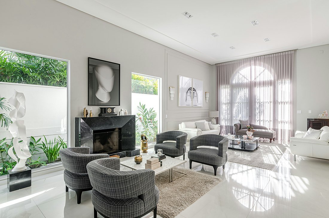 Refined residential living room interior with marble fireplace — representational imagery
